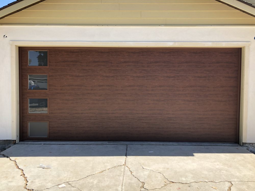 Dark wood-grain garage door with vertical window accents